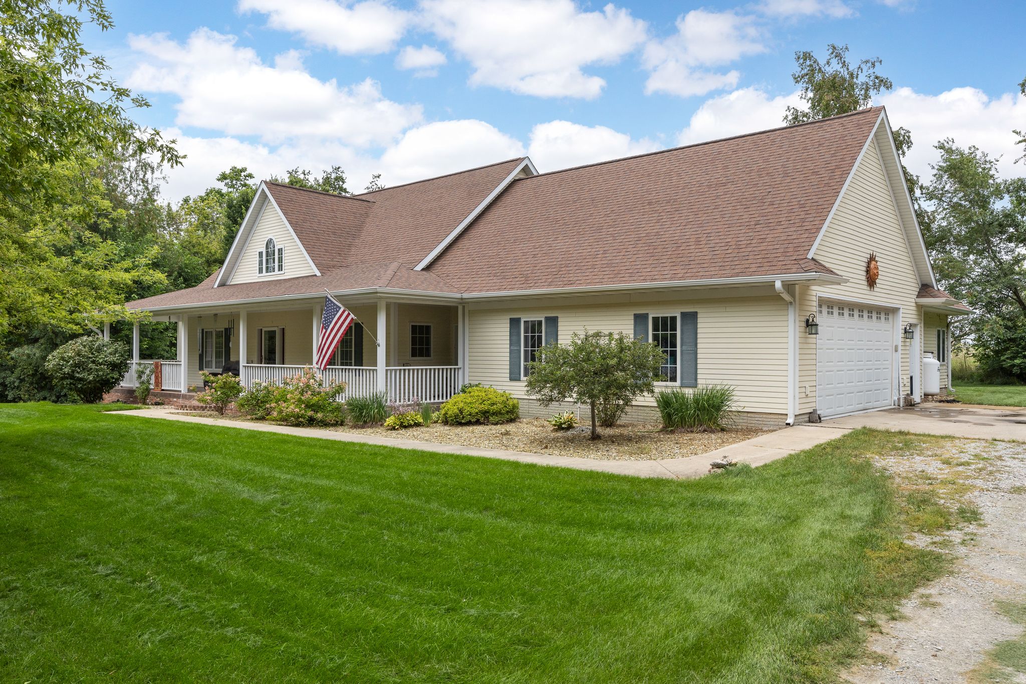 Front of 4518 Sutliff Road with its covered porch, garage, and lawn