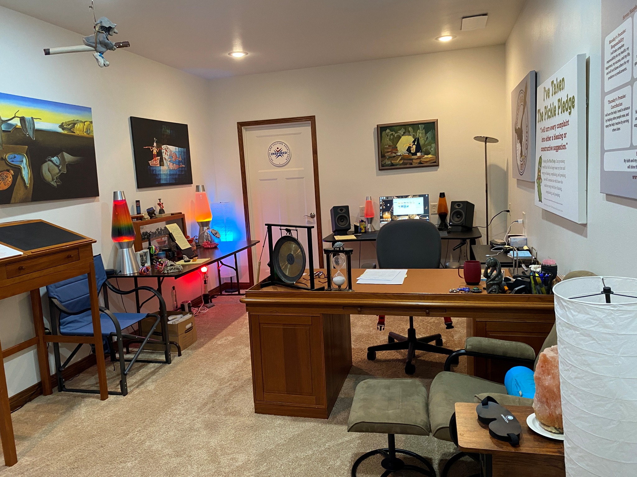 Main office downstairs with a writing desk and artwork
