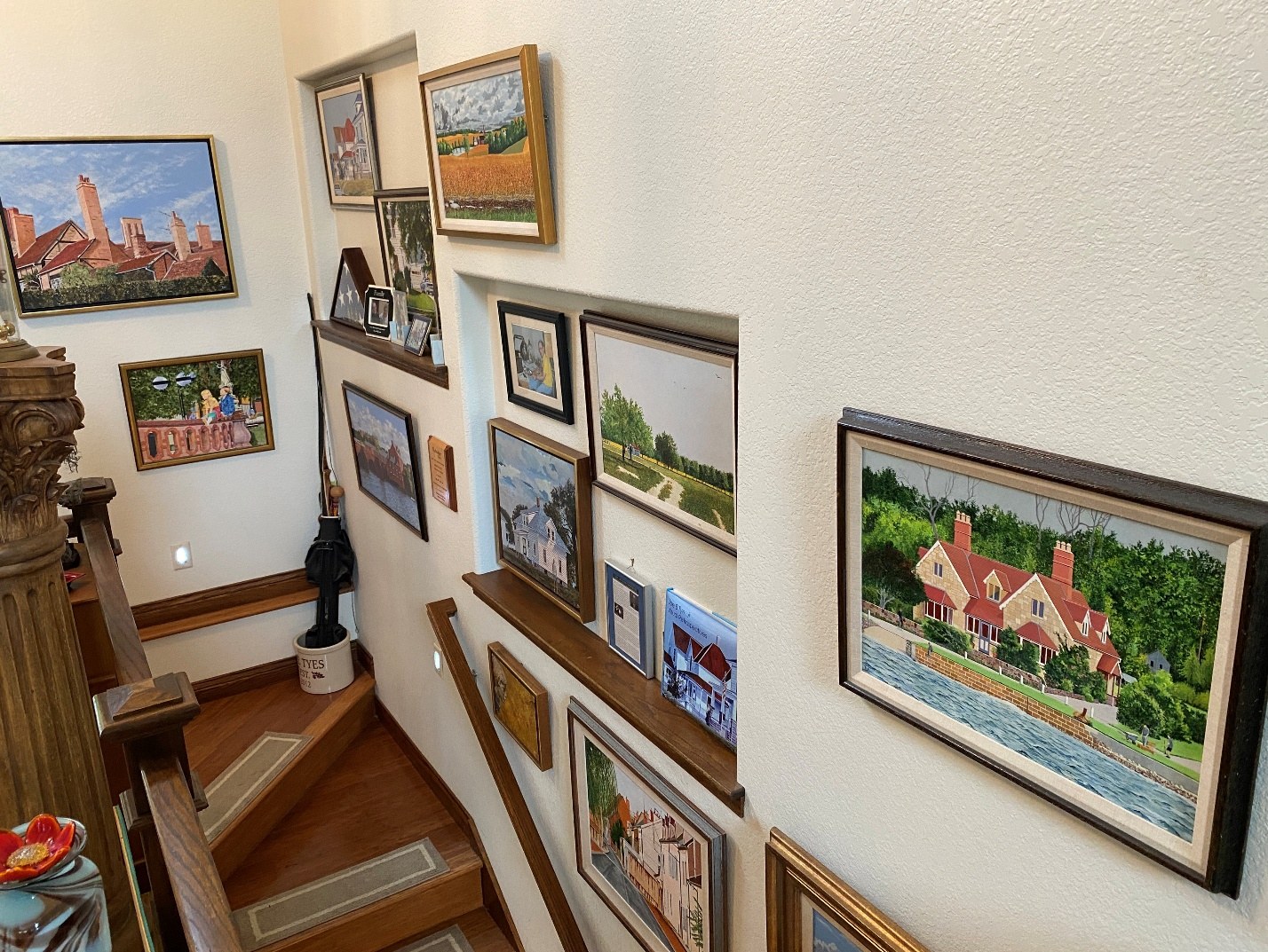 Original paintings displayed along the stairway