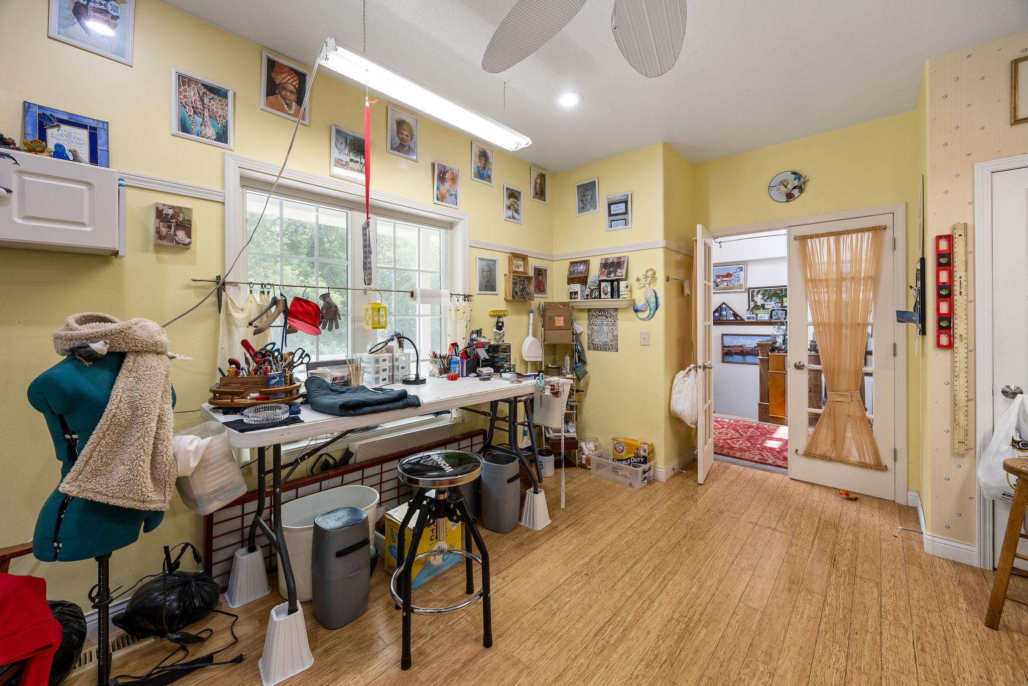 Sewing room with a worktable facing the front porch windows