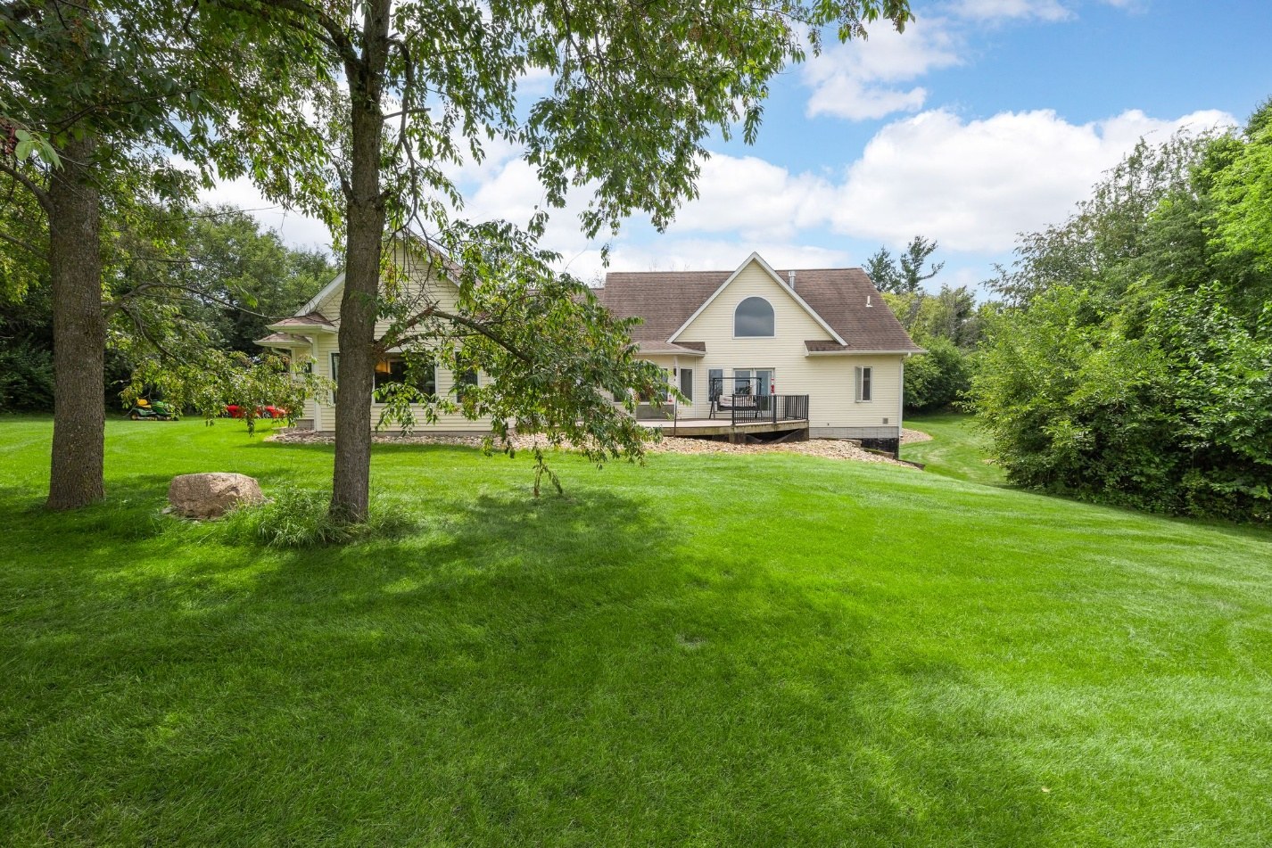 Rear of the home framed by trees